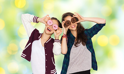 Image showing happy pretty teenage girls with donuts having fun