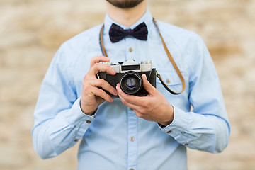 Image showing close up of hipster man with film camera in city