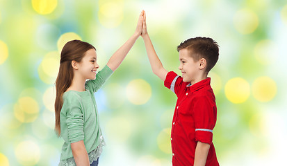 Image showing happy boy and girl making high five