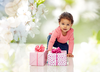 Image showing baby girl with birthday presents and confetti