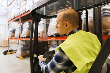 Image showing man operating forklift loader at warehouse