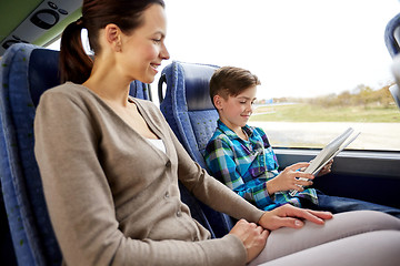 Image showing happy family with tablet pc sitting in travel bus