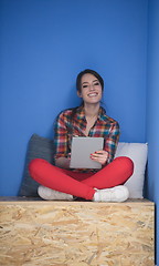 Image showing woman in crative box working on tablet