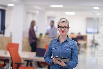 Image showing portrait of young business woman at office with team in backgrou