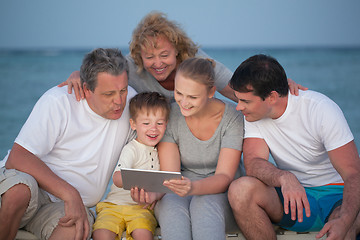 Image showing Happy big family with tablet PC on the beach