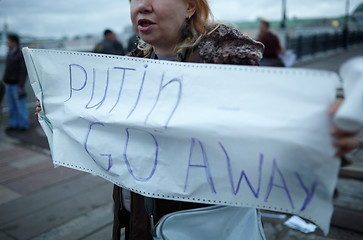 Image showing Woman holds a placard Putin Go Away.