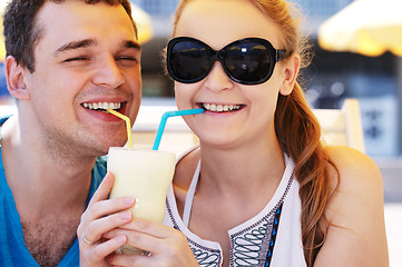 Image showing Romantic couple sharing a cocktail