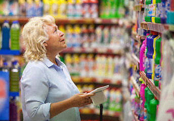 Image showing Woman with pad shopping for household detergents