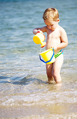 Image showing Adorable little boy playing in the sea