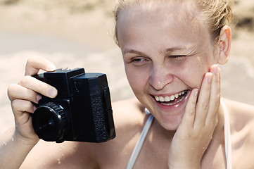 Image showing Woman laughing as she views a photo