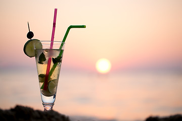 Image showing Mojito cocktail on the beach at sunset