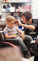 Image showing Little boy at the hairdresser