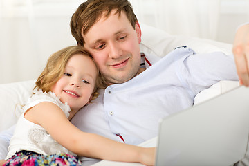 Image showing Happy dad and daughter with laptop