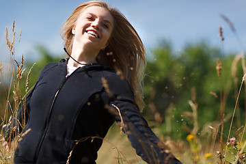 Image showing Young happy girl running in the field