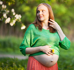 Image showing Pregnant woman in the light of evening sun outdoor