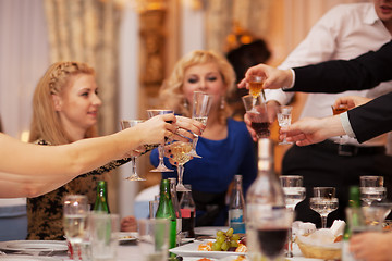 Image showing Friends raising their glasses in a toast