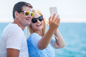 Image showing Happy summer selfie of young couple in sunglasses