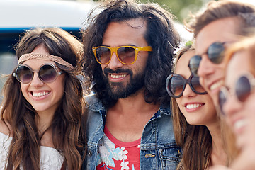 Image showing smiling young hippie friends over minivan car