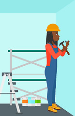 Image showing Constructor hammering nail.