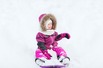 Image showing happy little kid on sled outdoors in winter