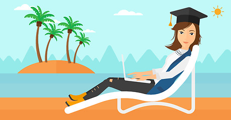 Image showing Graduate lying on chaise lounge with laptop.