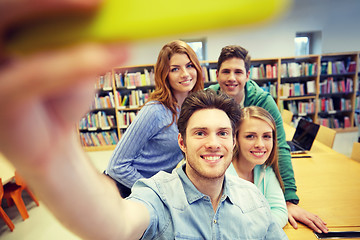 Image showing students with smartphone taking selfie in library