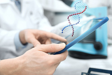 Image showing close up of scientists hands with tablet pc in lab