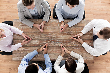 Image showing close up of business team sitting at table