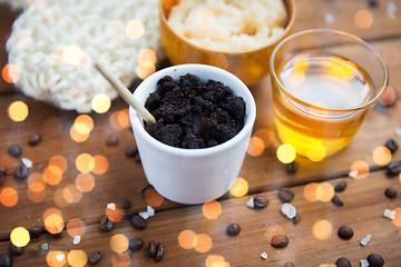 Image showing close up of coffee scrub in cup and honey on wood