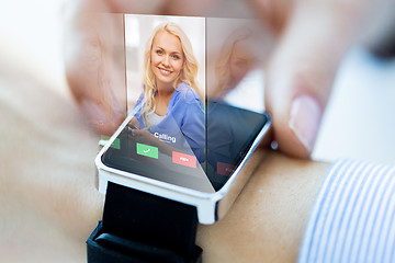 Image showing close up of hand with incoming call on smart watch