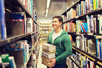 Image showing happy student or man with book in library