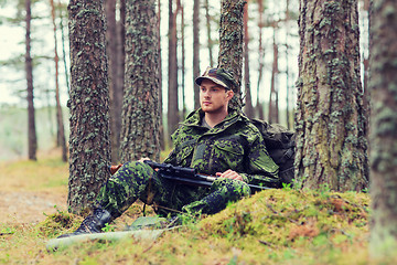 Image showing young soldier or hunter with gun in forest