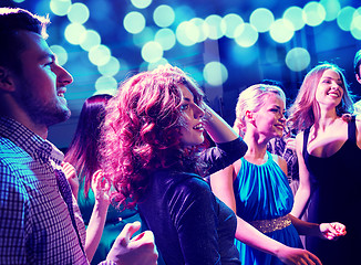 Image showing smiling friends dancing in club