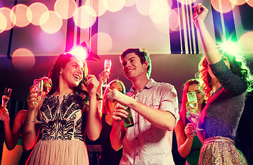 Image showing smiling friends with wine glasses and beer in club