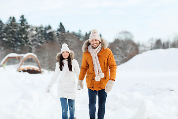 Image showing happy couple walking over winter background