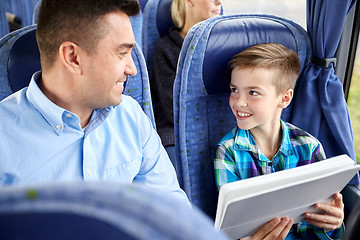 Image showing happy family with tablet pc sitting in travel bus