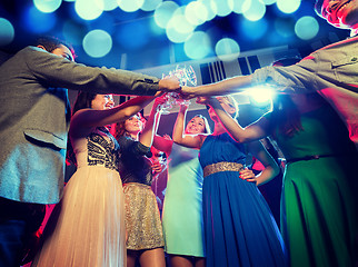 Image showing smiling friends with glasses of champagne in club