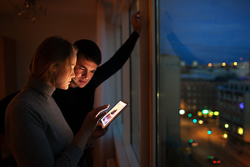 Image showing Couple with pad at home in the evening