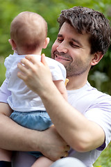 Image showing Loving father carrying his child