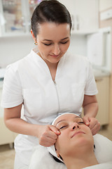 Image showing Woman under facial massage at beauty spa