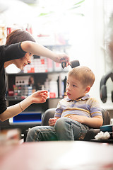 Image showing Little boy having a hair cut in salon