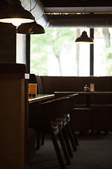 Image showing Empty cafe interior with wooden furniture and sofa