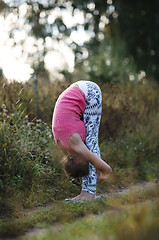 Image showing Supple young woman bending double