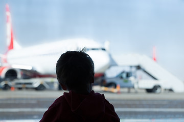 Image showing Little boy watching planes at the airport