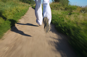 Image showing Running in the park. Detail of legs