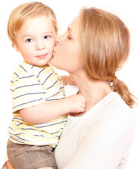 Image showing Young happy mother is kissing her child.