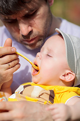 Image showing Daddy feeding toddler