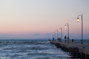 Image showing People walking along the pier in evening
