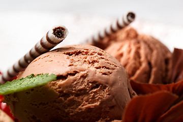 Image showing Chocolate ice cream with striped wafer biscuits