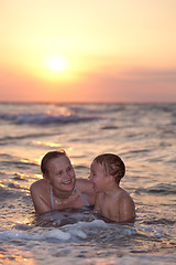 Image showing Mother enjoying an evening swim with her son